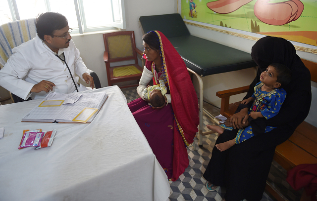 pakistani doctor dilip kumar speaks to a mother with her baby at mithi civil hospital in mithi photo afp