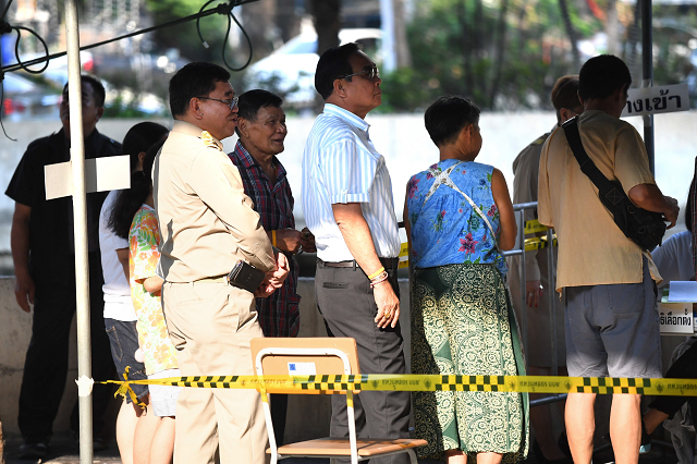 thai prime minister prayut chan o cha c waits in line to vote at a polling station in bangkok photo afp