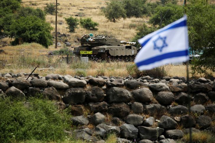 an israeli tank can be seen near the israeli side of the border with syria in the israeli occupied golan heights photo reuters