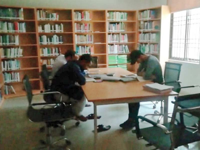people read near a window at e library photo express people read near a window at e library photo express