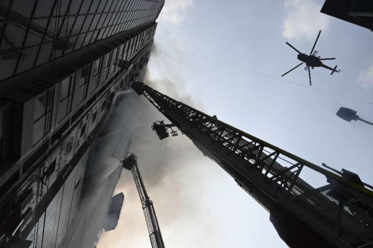 helicopters are seen at the 22 storey building that caught fire in dhaka