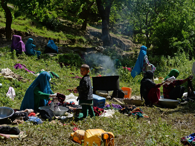 in this file photo taken on june 9 2014 afghan displaced women wash their clothes in an area affected by landslides and flash floods in the guzargah e nur district of the baghlan province photo afp