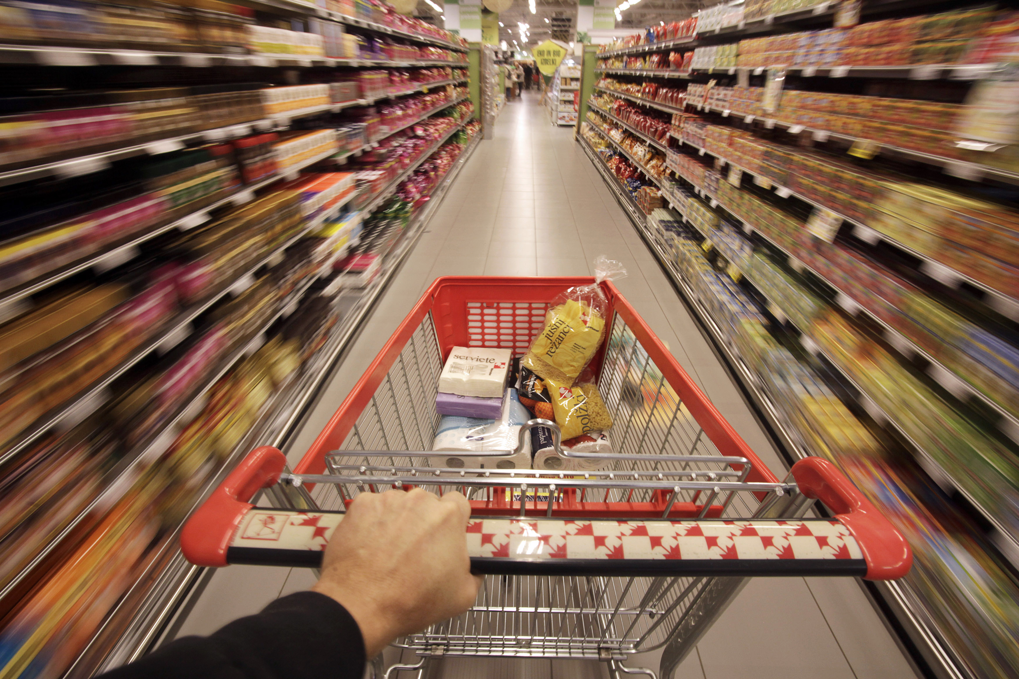 a shopping cart is pushed down the aisle in this reuters photo illustration
