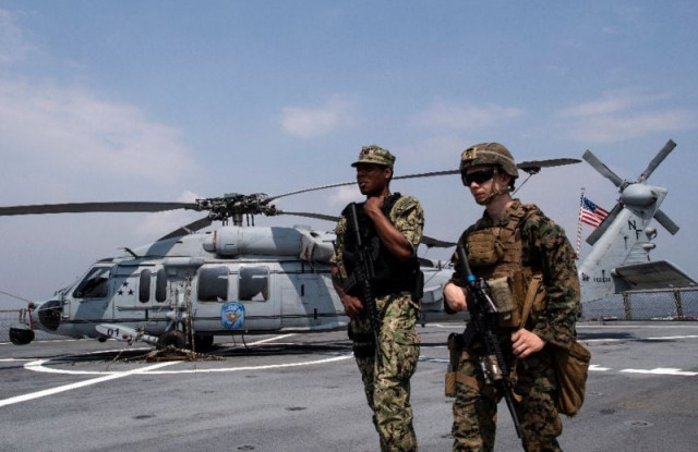 us navy personnel walk past a mh 60 helicopter after the uss blue ridge docks in manila bay photo afp us navy personnel walk past a mh 60 helicopter after the uss blue ridge docks in manila bay photo afp