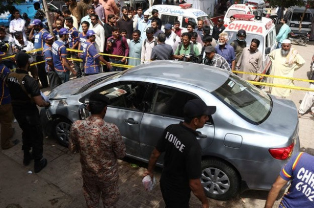 security personnel and onlookers gather around the car of leading religious scholar mufti taqi usmani after an attack by unidentified gunmen in karachi photo afp security personnel and onlookers gather around the car of leading religious scholar mufti taqi usmani after an attack by unidentified gunmen in karachi photo afp