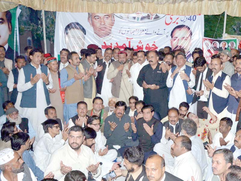 ppp workers offer dua at a ceremony held in rawalpindi to mark the death anniversary of za bhutto photo inp