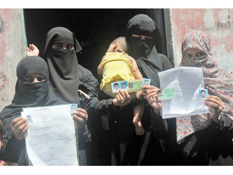 family members of pakistani fishermen who are imprisoned in indian jails hold up pictures of their loved ones seeking the government s help in securing their safe return photo ppi