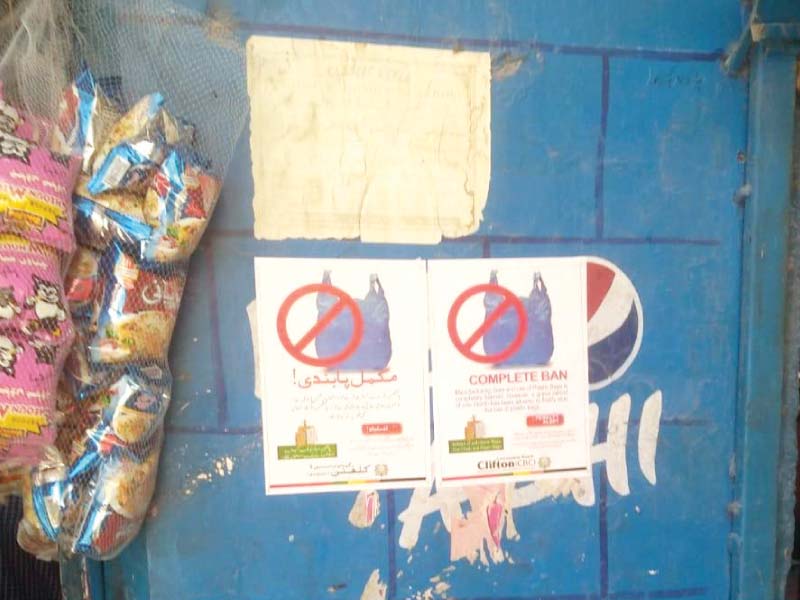 posters placed outside shops in clifton area warn against the use of plastic bags those who fail to comply will face heavy fines photo express