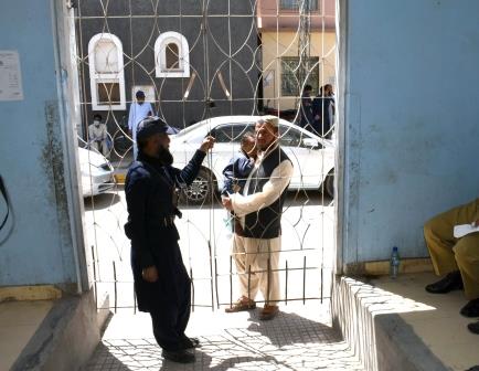 a security guard stands on duty as a patient waits outside the opd section of civil hospital quetta during doctors strike in the province photo express