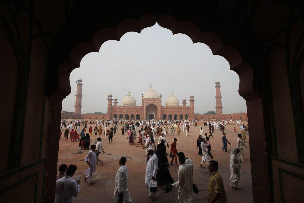 muslims walk near the badshahi mosque after attending a mass prayer for eid al adha in lahore pakistan photo reuters