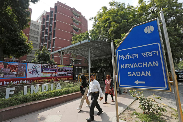 people walk past the election commission of india office building in new delhi india march 11 2019 photo reuters