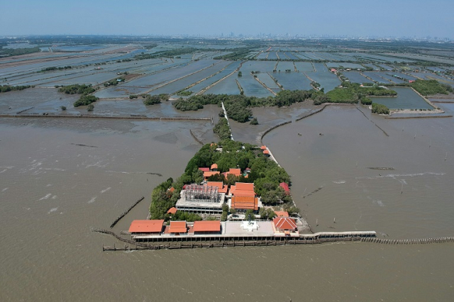 a dangerous combination of climate change industrial farming and rapid urbanisation are endangering the gulf of thailand 039 s coasts stripping away precious mangrove trees and leaving some buildings like the temple at samut chin surrounded by sea water photo afp a dangerous combination of climate change industrial farming and rapid urbanisation are endangering the gulf of thailand 039 s coasts stripping away precious mangrove trees and leaving some buildings like the temple at samut chin surrounded by sea water photo afp