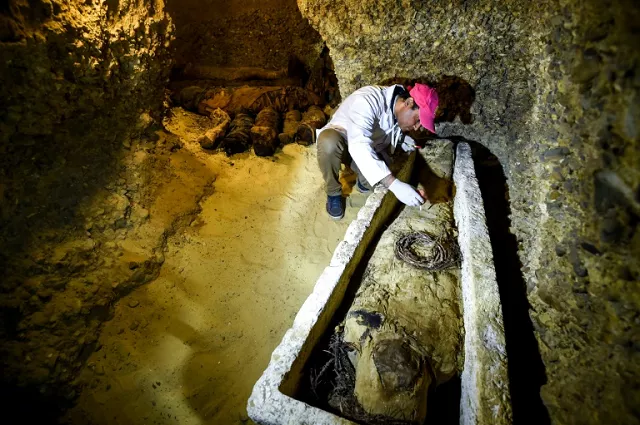 an archaeologist brushes a newly discovered mummy laid inside a sarcophagus part of a collection found in burial chambers dating to the ptolemaic era 323 30 bc in february 2019 photo afp an archaeologist brushes a newly discovered mummy laid inside a sarcophagus part of a collection found in burial chambers dating to the ptolemaic era 323 30 bc in february 2019 photo afp