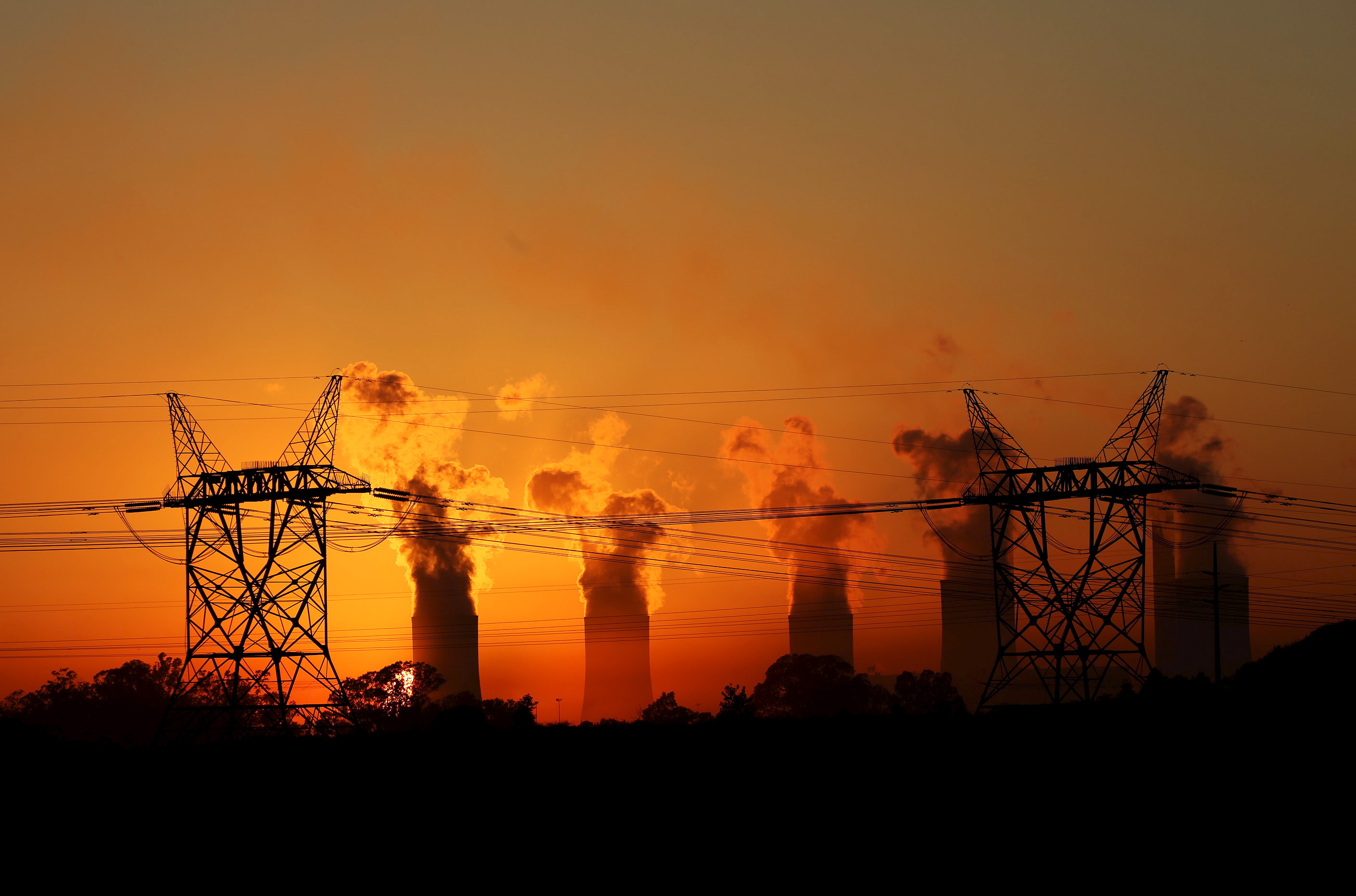 electricity pylons are seen in front of the cooling towers photo reuters