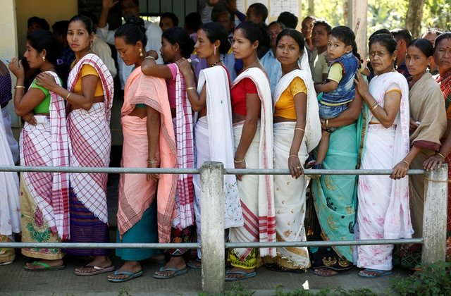 people line up to cast their votes outside a polling station in majuli a large river island in the brahmaputra river in the northeastern indian state of assam india april 11 2019 photo reuters