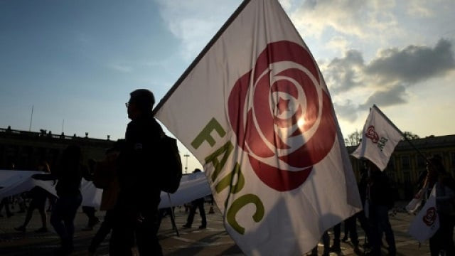 people hold flags of the common alternative revolutionary force farc party during a protest against a reform proposed by the government for the special jurisdiction for peace jep in bogota on march 13 2019 people hold flags of the common alternative revolutionary force farc party during a protest against a reform proposed by the government for the special jurisdiction for peace jep in bogota photo afp file people hold flags of the common alternative revolutionary force farc party during a protest against a reform proposed by the government for the special jurisdiction for peace jep in bogota on march 13 2019 people hold flags of the common alternative revolutionary force farc party during a protest against a reform proposed by the government for the special jurisdiction for peace jep in bogota photo afp file