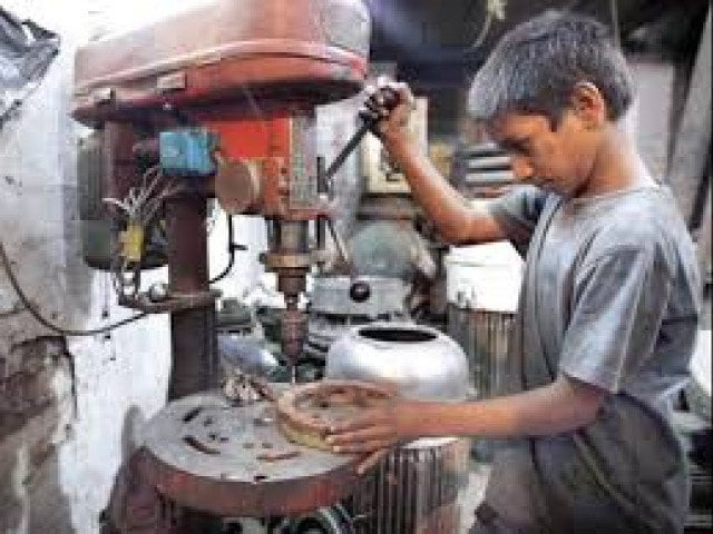 a child labourer operates a drill machine at a workshop in lahore photo app a child labourer operates a drill machine at a workshop in lahore photo app