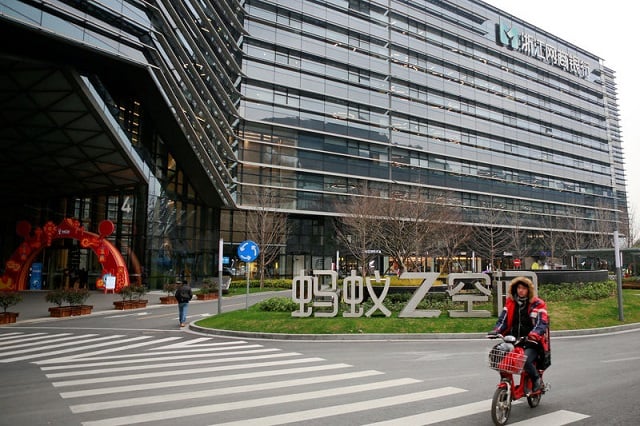 a man cycles past a building bearing the logo of mybank an online lender that is an offshoot of alibaba at the ant financial services headquarters in hangzhou zhejiang province china january 24 2018 photo reuters