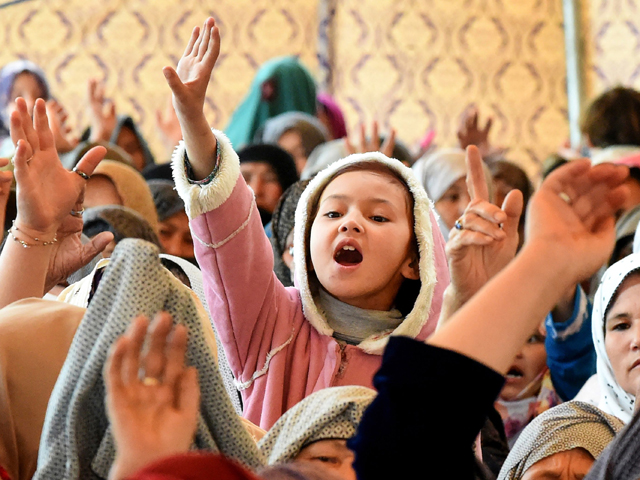 a young pakistani mourner of the shia hazara ethnic minority shout slogan as she sits in during a protest in quetta on april 15 2019 photo afp