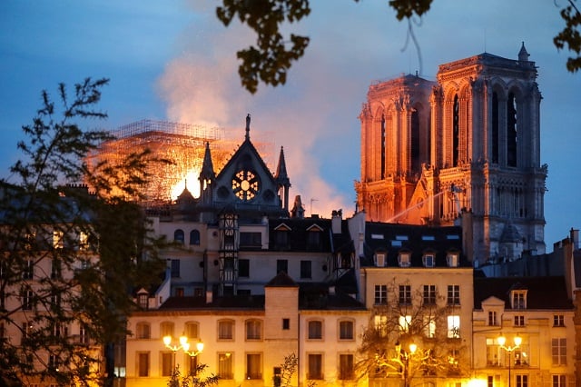 firefighter douse flames billowing from the roof at notre dame cathedral in paris on april 15 2019   a major fire broke out at the landmark notre dame cathedral in central paris sending flames and huge clouds of grey smoke billowing into the sky the fire service said the flames and smoke plumed from the spire and roof of the gothic cathedral visited by millions of people a year where renovations are currently underway photo afp