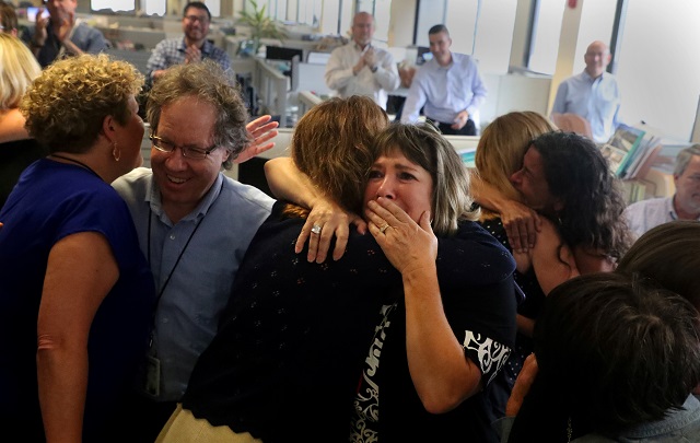 staff of the south florida sun sentinel celebrate their bittersweet honour after winning the pulitzer prize for public service for its coverage of the parkland school shooting in the newsroom in deerfield beach florida photo reuters