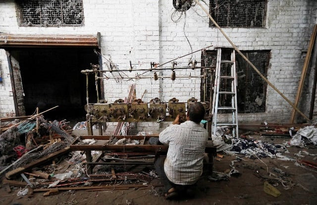 file photo a scrap dealer dismantles a winding machine at a weaving factory that was shut a year ago in panipat in the northern state of haryana india photo reuters file photo a scrap dealer dismantles a winding machine at a weaving factory that was shut a year ago in panipat in the northern state of haryana india photo reuters