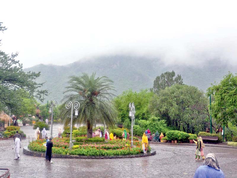 visitors enjoy the wet spell at daman e koh in the capital photo inp