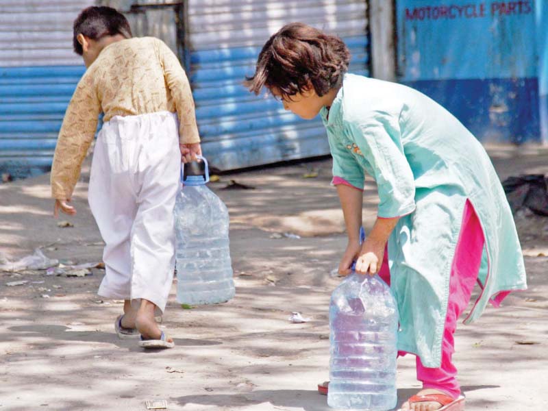 children carry water cans to their homes in martin quarters on friday citizens have been forced to bear the brunt of water shortages as the water mafia continues to steal water from illegal hydrants set up across the city photo online