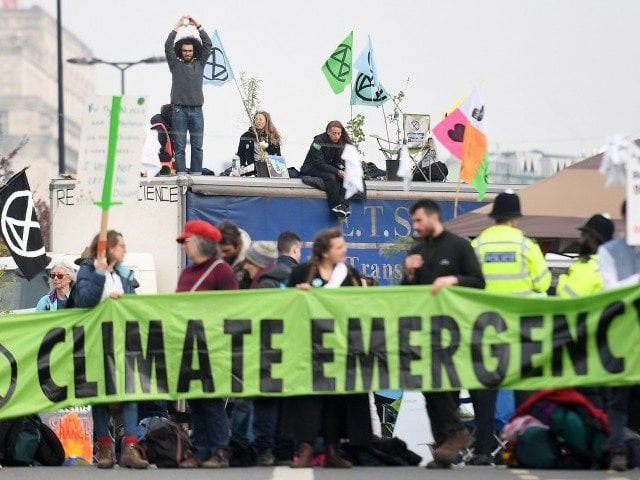 activists hold banners and wave flags as they continue to block the road on waterloo bridge on the second day of an environmental protest by the extinction rebellion group in london on april 16 2019 environmental protesters from the extinction rebellion campaign group started a programme of demonstrations designed to block five of london 039 s busiest and iconic locations to draw attention to what they see as the quot ecological and climate emergency quot of climate change photo afp file activists hold banners and wave flags as they continue to block the road on waterloo bridge on the second day of an environmental protest by the extinction rebellion group in london on april 16 2019 environmental protesters from the extinction rebellion campaign group started a programme of demonstrations designed to block five of london 039 s busiest and iconic locations to draw attention to what they see as the quot ecological and climate emergency quot of climate change photo afp file