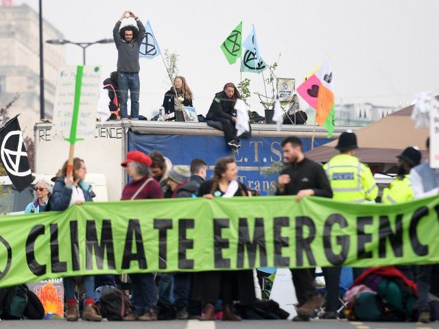 activists hold banners and wave flags as they continue to block the road on waterloo bridge on the second day of an environmental protest by the extinction rebellion group in london on april 16 2019   environmental protesters from the extinction rebellion campaign group started a programme of demonstrations designed to block five of london 039 s busiest and iconic locations to draw attention to what they see as the quot ecological and climate emergency quot of climate change photo afp file