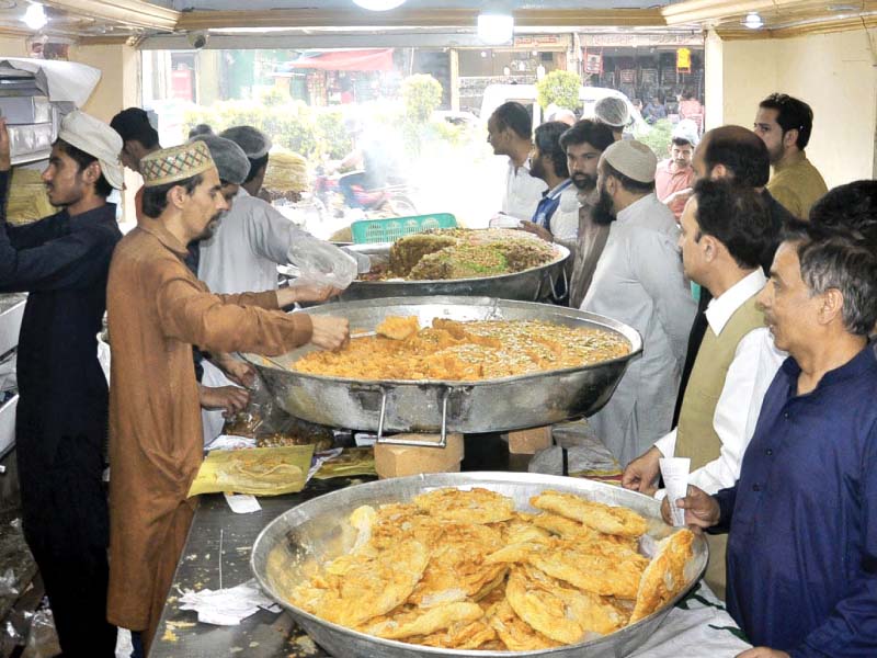 people buying sweets on the eve of shab e bharat while police show seized fireworks photos express agencies