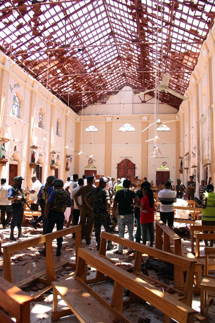 sri lankan security personnel walk past debris following an explosion in st sebastian 039 s church in negombo north of the capital colombo a series of eight devastating bomb blasts ripped through high end hotels and churches holding easter services in sri lanka photo afp