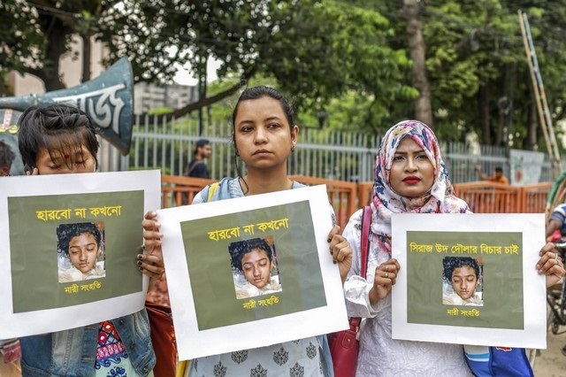 in this photo taken on april 12 2019 bangladeshi women hold placards and photographs of schoolgirl nusrat jahan rafi at a protest in dhaka following her murder by being set on fire after she had reported a sexual assault   a schoolgirl was burned to death in bangladesh on the orders of her head teacher after she reported him for sexually harassing her police said april 19 the death of 19 year old nusrat jahan rafi last week sparked protests across the south asian nation with the prime minister promising to prosecute all those involved photo afp file