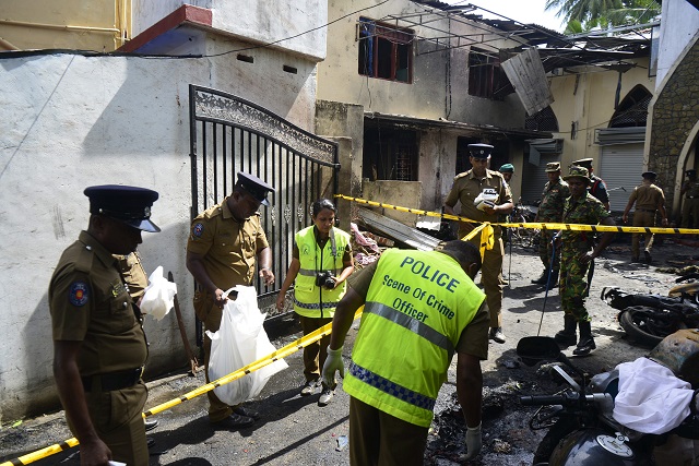 sri lankan security personnel and police investigators look through debris outside zion church following an explosion in batticaloa in eastern sri lanka on april 21 2019   a series of eight devastating bomb blasts ripped through high end hotels and churches holding easter services in sri lanka on april 21 killing nearly 160 people including dozens of foreigners photo afp