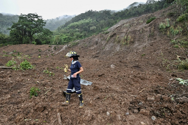 a rescue worker searches for victims after a landslide in rosas colombia on april 21 2019 photo afp