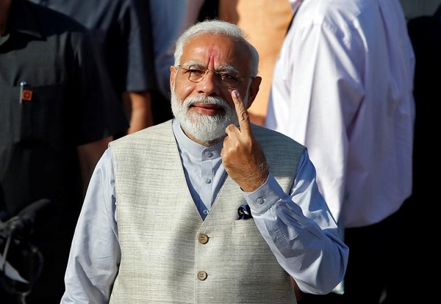 prime minister narendra modi shows his ink marked finger after casting his vote outside a polling station during the third phase of general election in ahmedabad april 23 2019 photo reuters