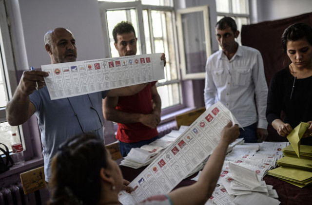 election officials hold ballot papers with the names of political parties participating in the nationwide legislative election as they count votes photo afp election officials hold ballot papers with the names of political parties participating in the nationwide legislative election as they count votes photo afp