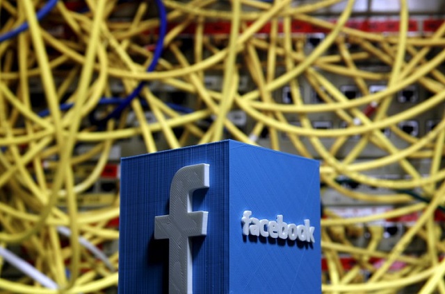 a 3d plastic representation of the facebook logo is seen in front of displayed cables in this illustration in zenica bosnia and herzegovina may 13 2015 photo reuters
