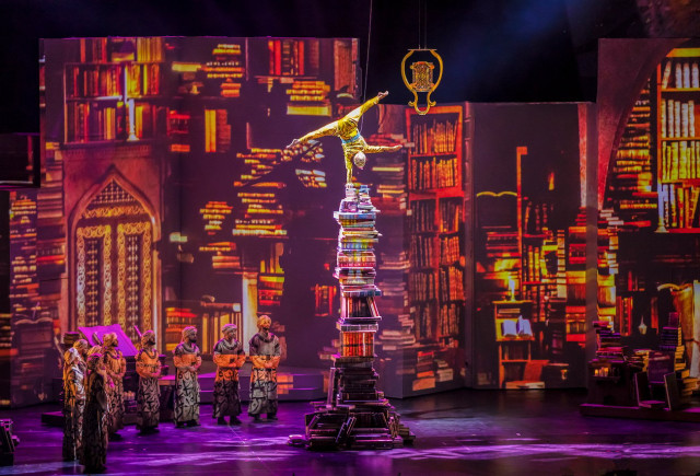 a performer atop a pile of books during the premiere of 1001 nights the last chapter at world book capital opening ceremony in sharjah united arab emirates photo express a performer atop a pile of books during the premiere of 1001 nights the last chapter at world book capital opening ceremony in sharjah united arab emirates photo express