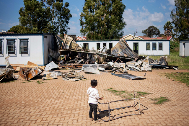 a young child belonging to the coloured community of eldorado park stands on april 18 2019 in the courtyard of the oakdale secondary school on the outskirts of johannesburg where several classrooms were destroyed during a student strike on april 15 photo afp a young child belonging to the coloured community of eldorado park stands on april 18 2019 in the courtyard of the oakdale secondary school on the outskirts of johannesburg where several classrooms were destroyed during a student strike on april 15 photo afp