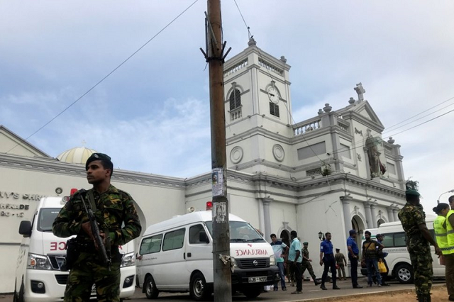 sri lankan military officials stand guard in front of st anthony 039 s shrine in colombo after a blast on april 21 photo reuters