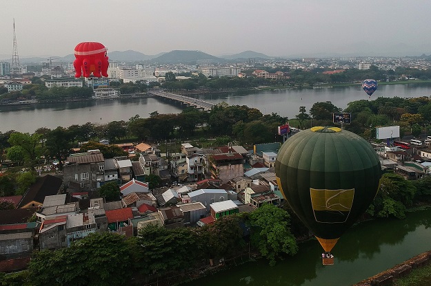 this aerial photograph shows hot air balloons flying over the the former capital 039 s stone citadel during a hot air balloon festival in the central vietnamese city of hue on april 28 2019 photo afp