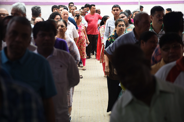 indian voters wait for start of voting at a polling booth in mumbai photo afp