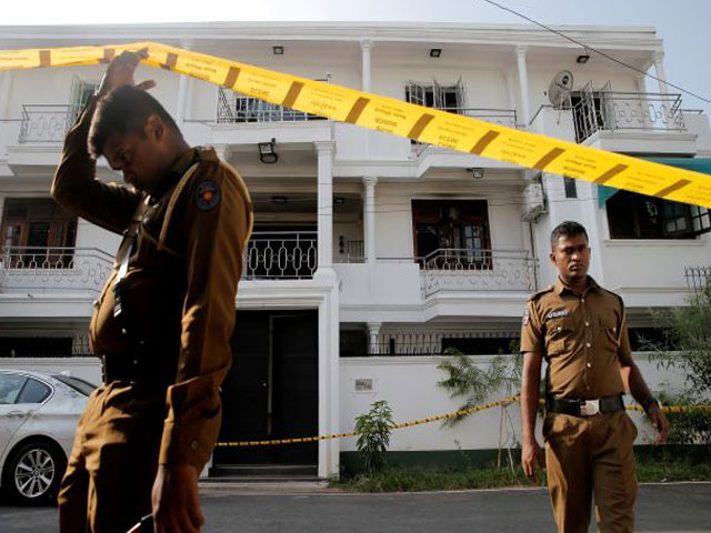 police keep watch outside the family home of a bomber suspect where an explosion occurred during a special task force raid following a string of suicide attacks on churches and luxury hotels in colombo photo reuters