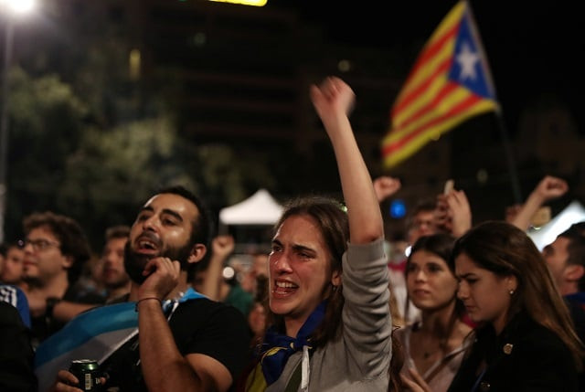 people react as they listen to former catalan president carles puigdemont during a gathering at plaza catalunya after voting ended for the banned independence referendum in barcelona spain on october 1 2017 photo reuters people react as they listen to former catalan president carles puigdemont during a gathering at plaza catalunya after voting ended for the banned independence referendum in barcelona spain on october 1 2017 photo reuters