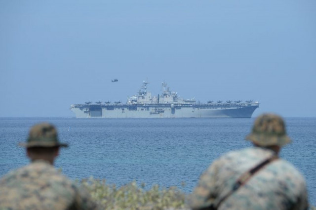 us marines watch the us navy multipurpose amphibious assault ship 039 uss wasp 039 with f 35 lightning fighter jets on the deck during the annual joint us philippines military exercise on april 11 2019 photo afp us marines watch the us navy multipurpose amphibious assault ship 039 uss wasp 039 with f 35 lightning fighter jets on the deck during the annual joint us philippines military exercise on april 11 2019 photo afp
