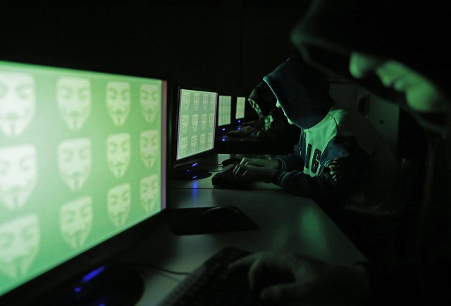 people pose in front of a display showing the word 039 cyber 039 in binary code in this picture illustration taken in zenica december 27 2014 photo reuters