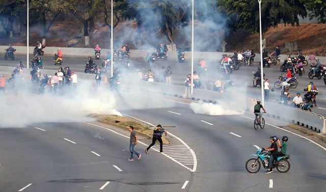 people react to tear gas near the generalisimo francisco de miranda airbase quot la carlota quot in caracas venezuela april 30 2019 photo reuters people react to tear gas near the generalisimo francisco de miranda airbase quot la carlota quot in caracas venezuela april 30 2019 photo reuters