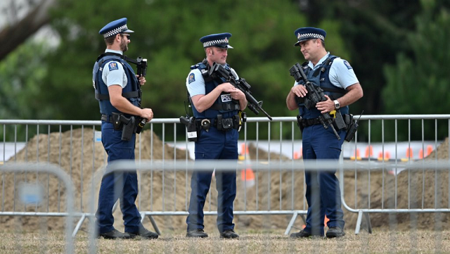 armed police officers patrol gravesites for victims in christchurch on march 18 2019 three days after a shooting incident killed at least fifty people in mosques in the city photo afp