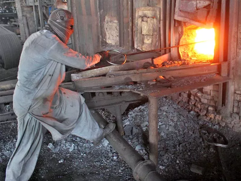 a labourer works at a furnace in peshawar on may day photo inp a labourer works at a furnace in peshawar on may day photo inp